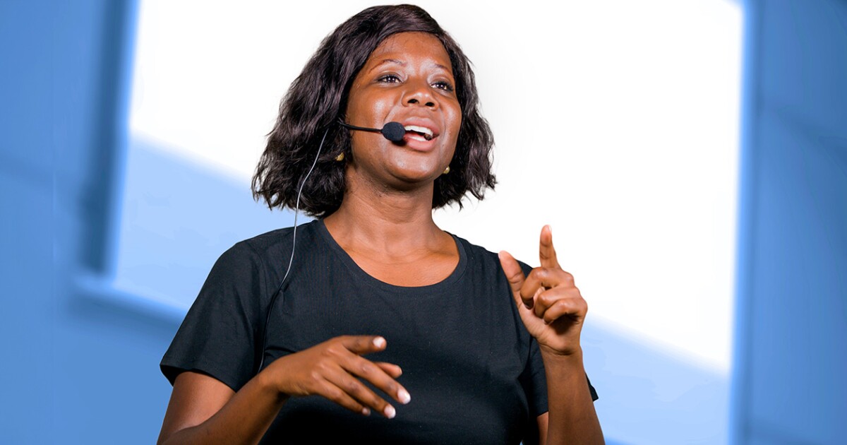 Woman with headset speaking at a conference