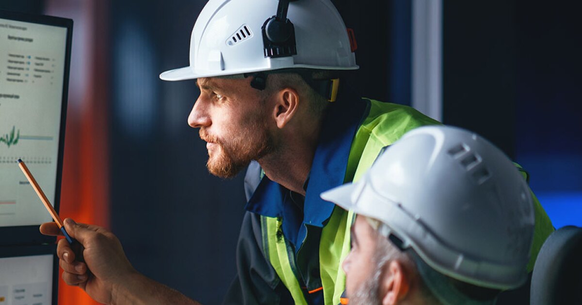 Two engineers looking at a computer screen.